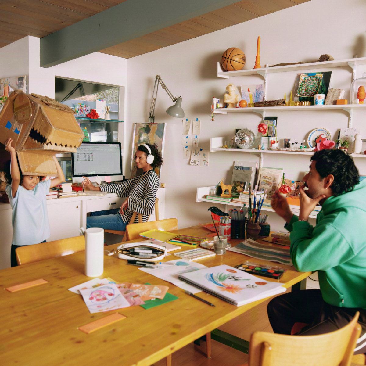 Two people sharing a table, one wearing Sonos Ace Ultra